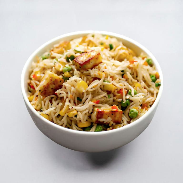 A rice bowl with seared paneer and vegetables